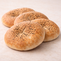 Four mardin village breads with poppy seeds on a light background